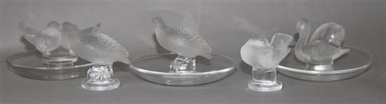 A Lalique opalescent glass ring tray, two others ring trays and two birds